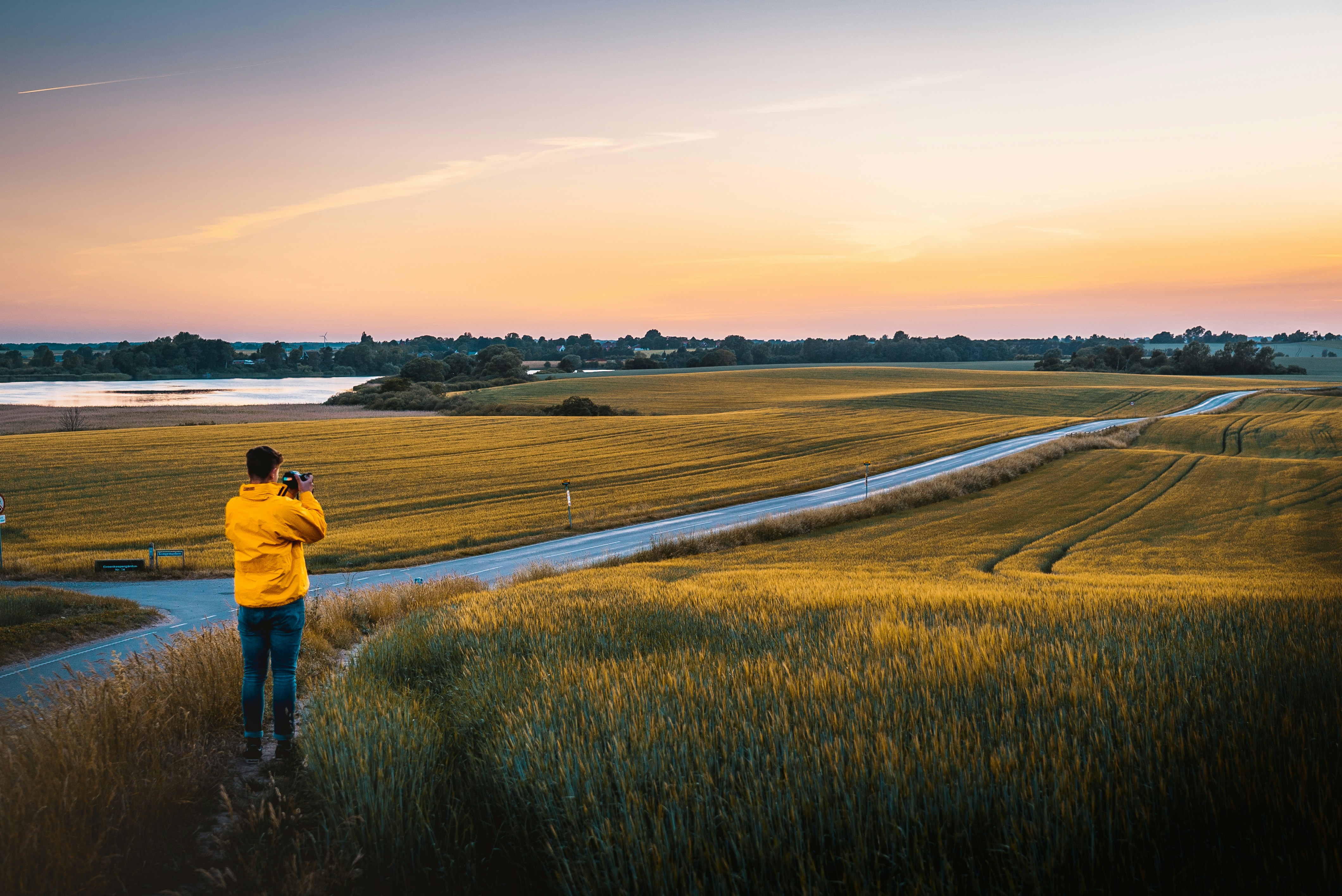 man taking photo of grassland