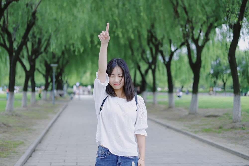 woman raising her right arm