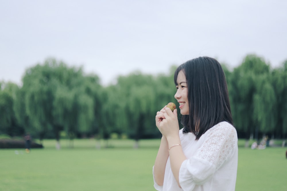 selective focus photography of woman holding brown bal