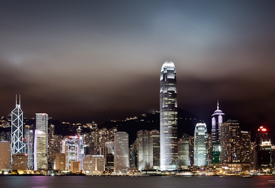 landscape photo of city buildings during night in Victoria Harbour Hong Kong
