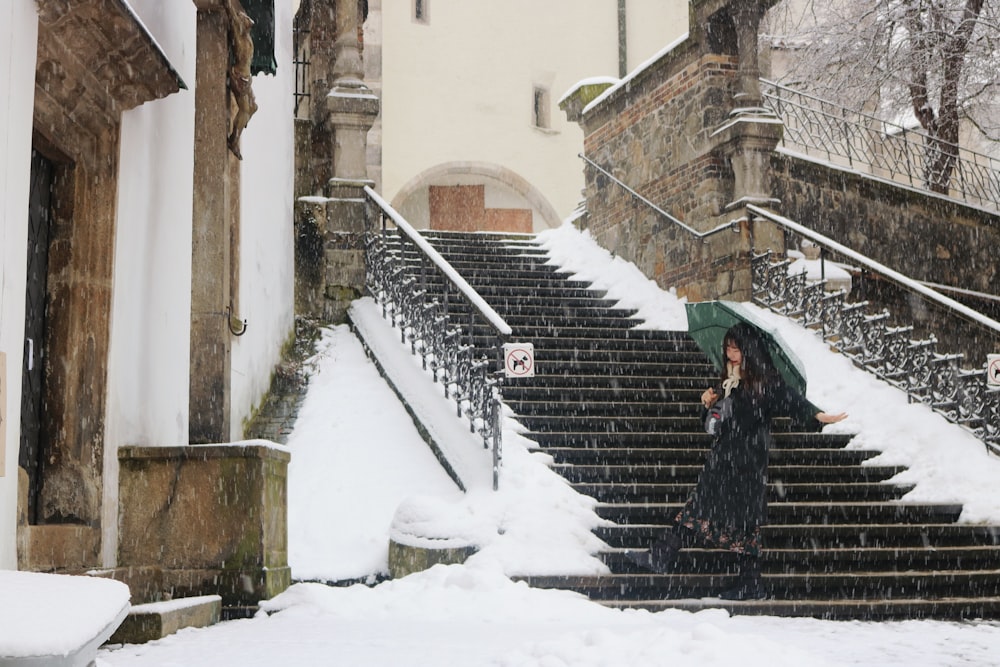 woman holding umbrella walking on stair