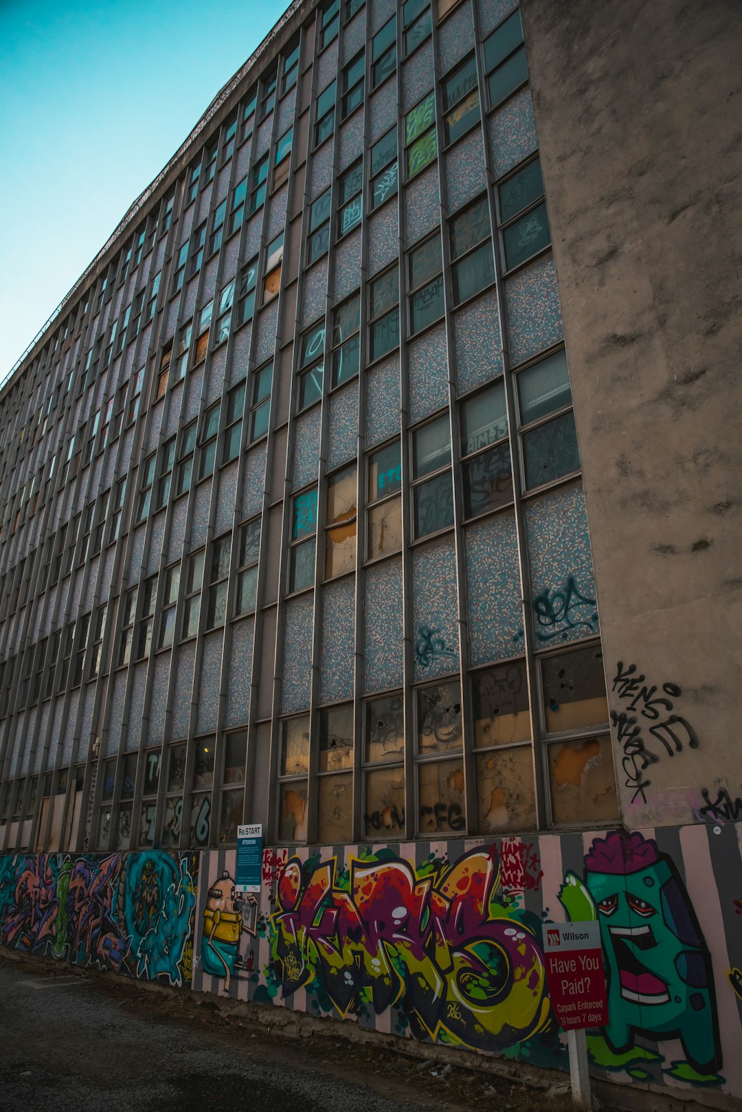 building with glass windows and murals