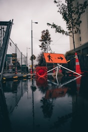 orange and white traffic cone near light post during daytime