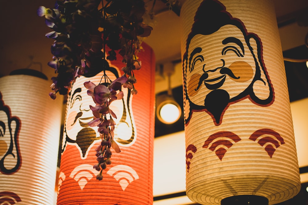 three assorted-color paper lamps hanged on ceiling