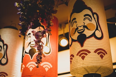 three assorted-color paper lamps hanged on ceiling jolly teams background