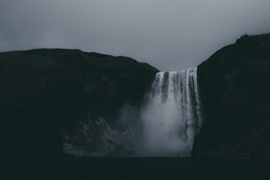 low-angle photography of waterfalls under cloudy sky in Skógafoss Iceland