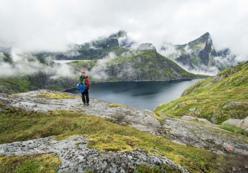 person standing on top of mountain during daytime