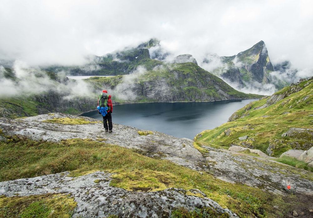 person standing on top of mountain during daytime