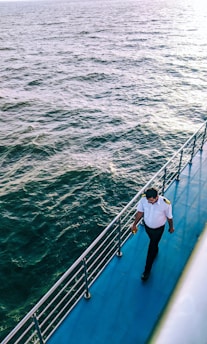 man walking on blue boat surface