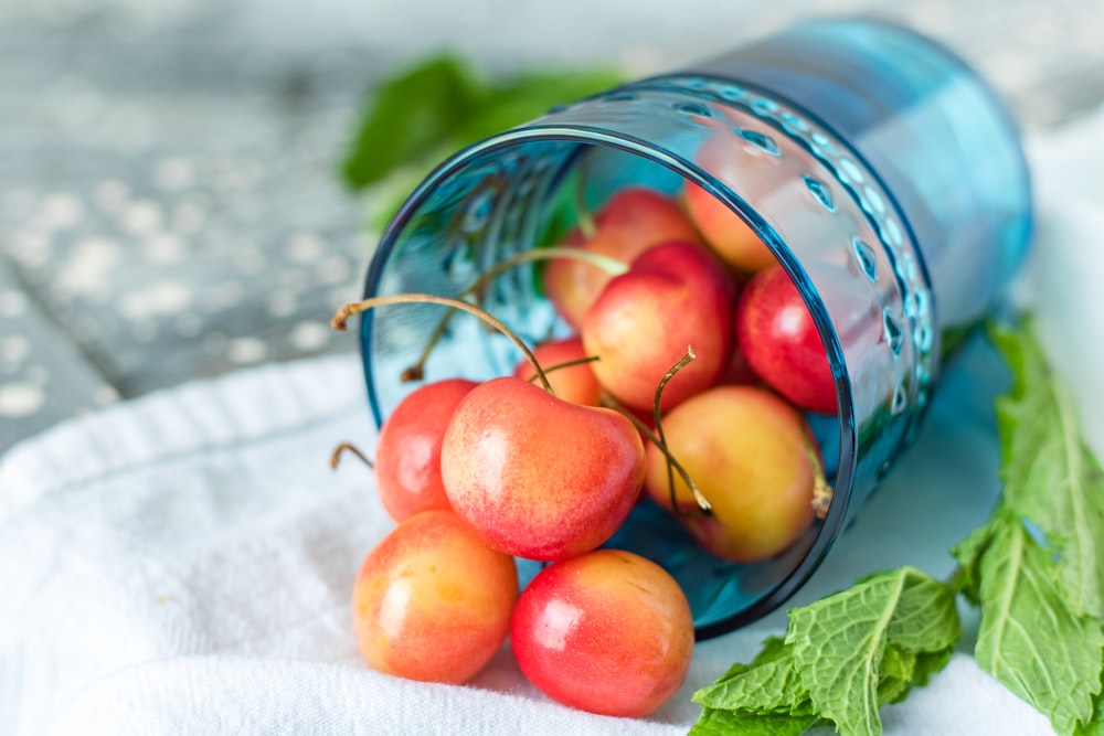 bunch of cherry in drinking glass