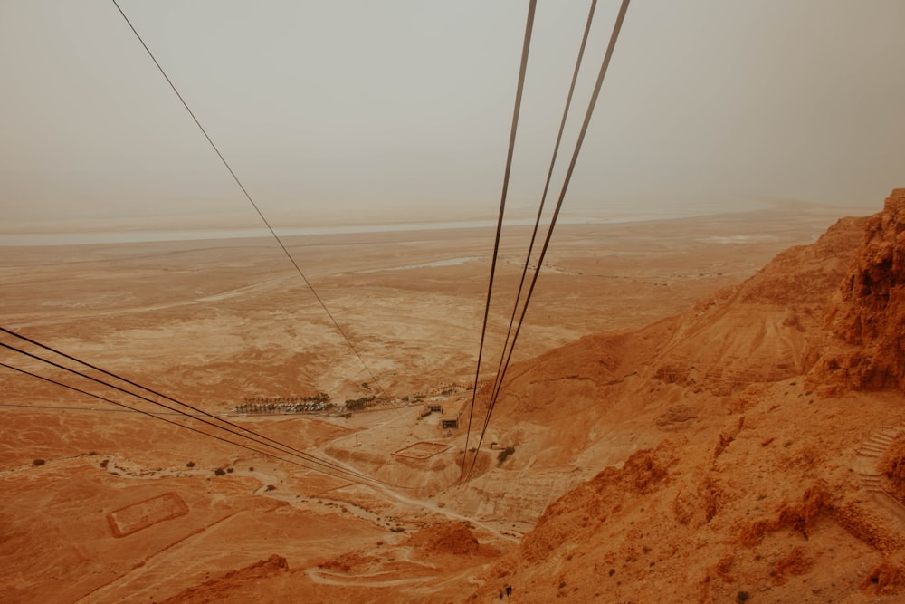 an aerial view of a desert with power lines in the foreground