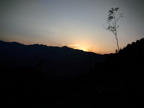 A serene landscape with a sunset, symbolizing new beginnings and the closing of chapters.