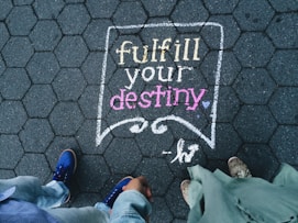 two person standing on full your destiny pavement artwork