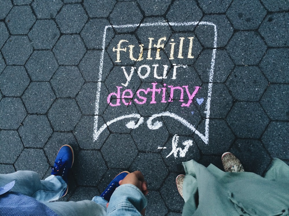 Sidewalk art of a book saying "Fulfill your Destiny"