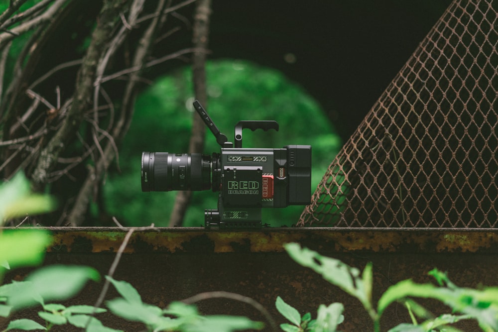 black studio camera on top on brown bar