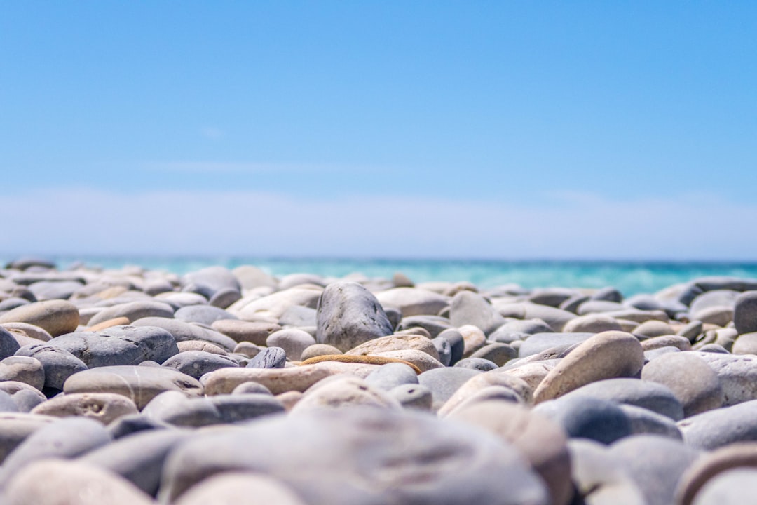 photo of stones near body of water