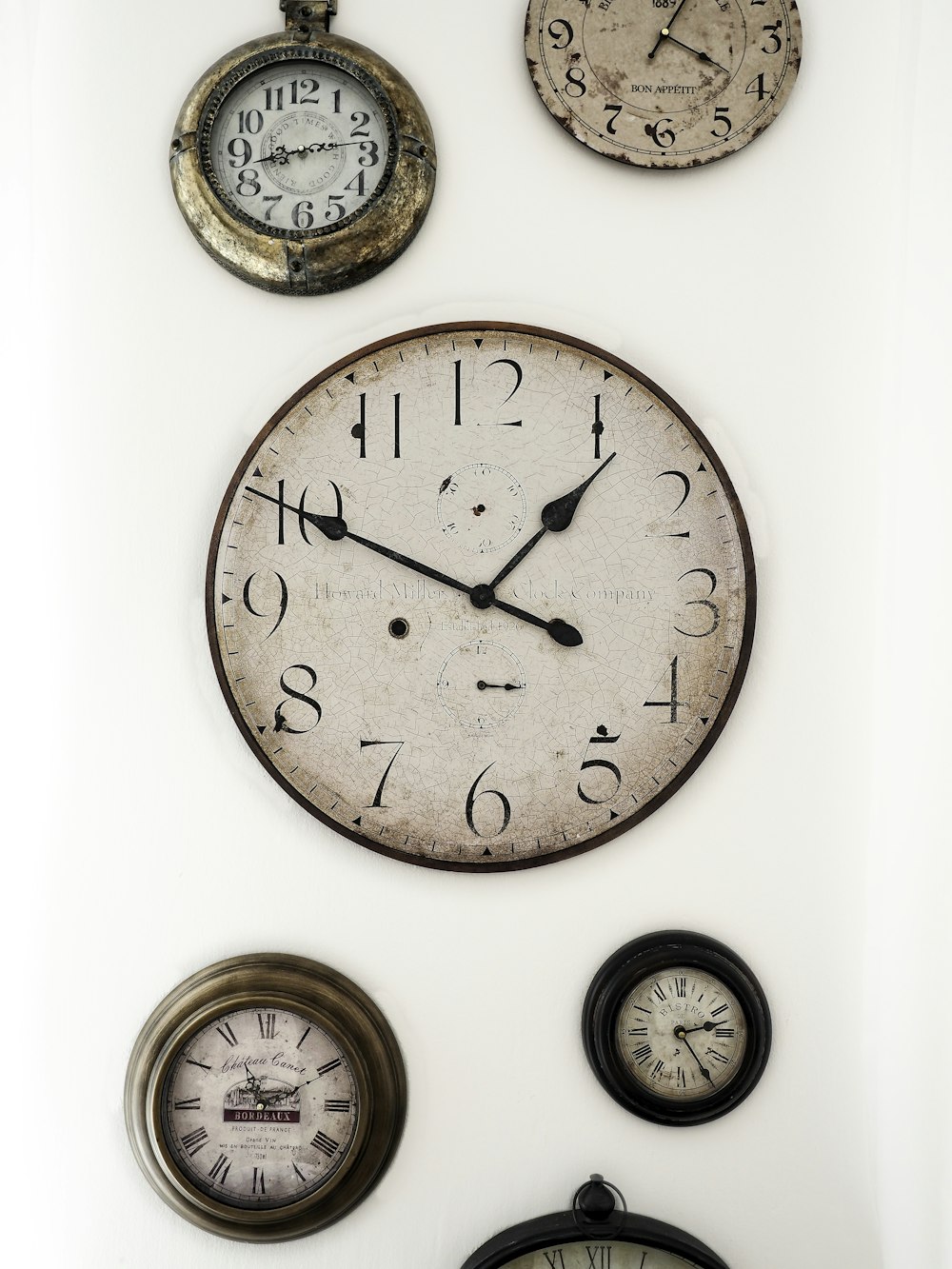 a group of clocks mounted to the side of a wall