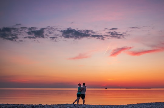 couple hugging each other near seashore in Goderich Canada