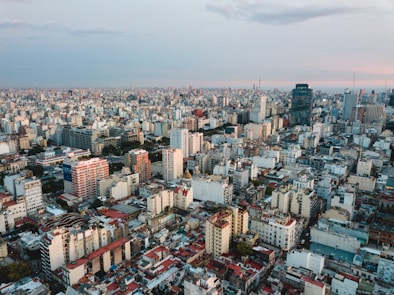 aerial view of city under cloudy sky during daytime