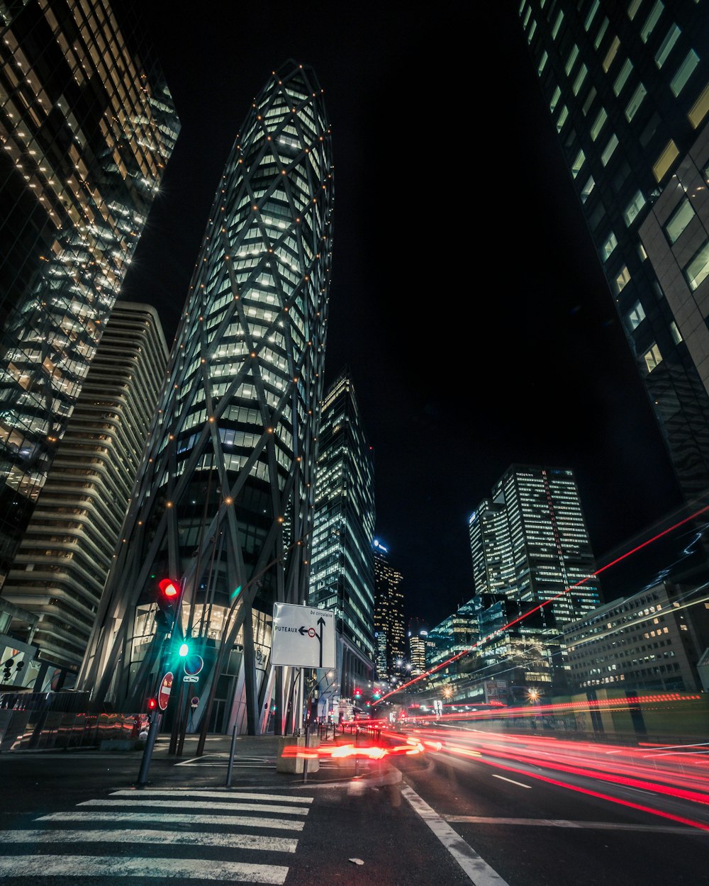 time-lapse photography of car traveling in street beside high rise building