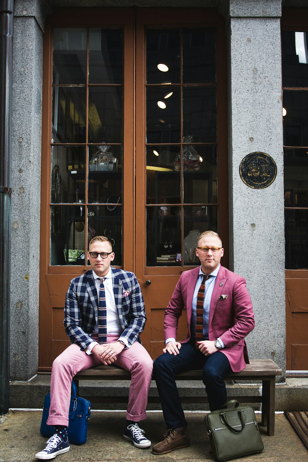 two man in formal suit sitting on bench chair