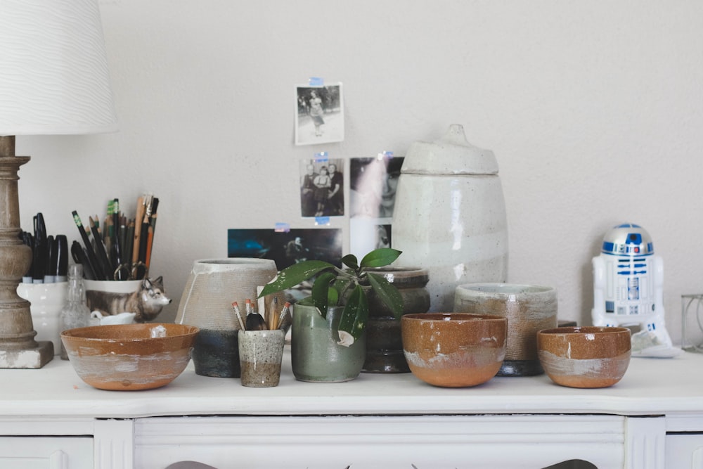 brown ceramic bowl on white wooden sideboard