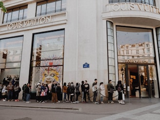 people queuing beside Louis Vuitton store