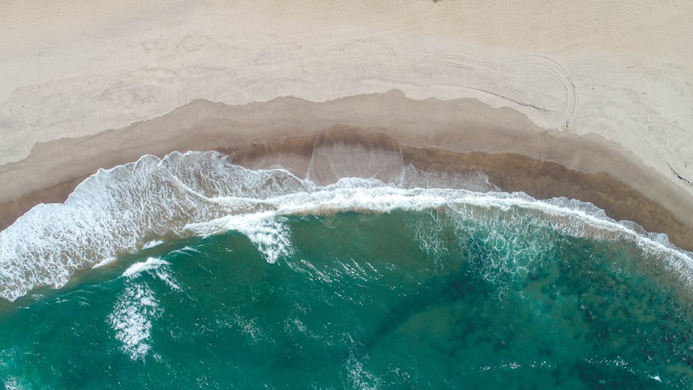 ocean waves hitting shore aerial photo