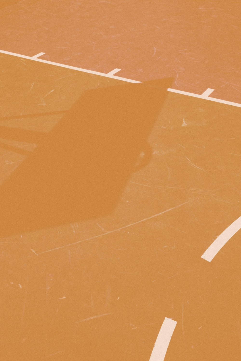 basketball hoop casting shadow on line