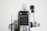 A close-up view of a vintage machine manufactured by Kingsley Machine Co. The machine features metal components, with visible bolts and screws, and includes a label displaying the company's name along with patent details. The background is slightly blurred, emphasizing the focus on the machine.