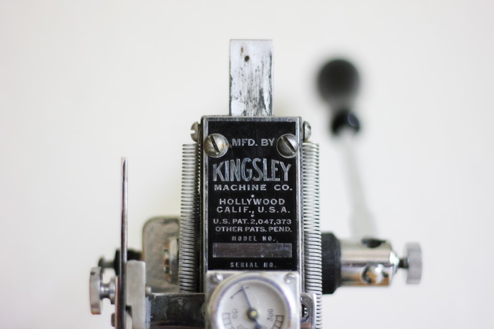 gray and black Kingsley hand lever machine