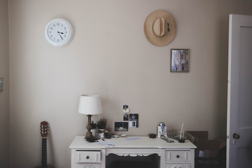 table lamp on knee-hole desk beside closed door