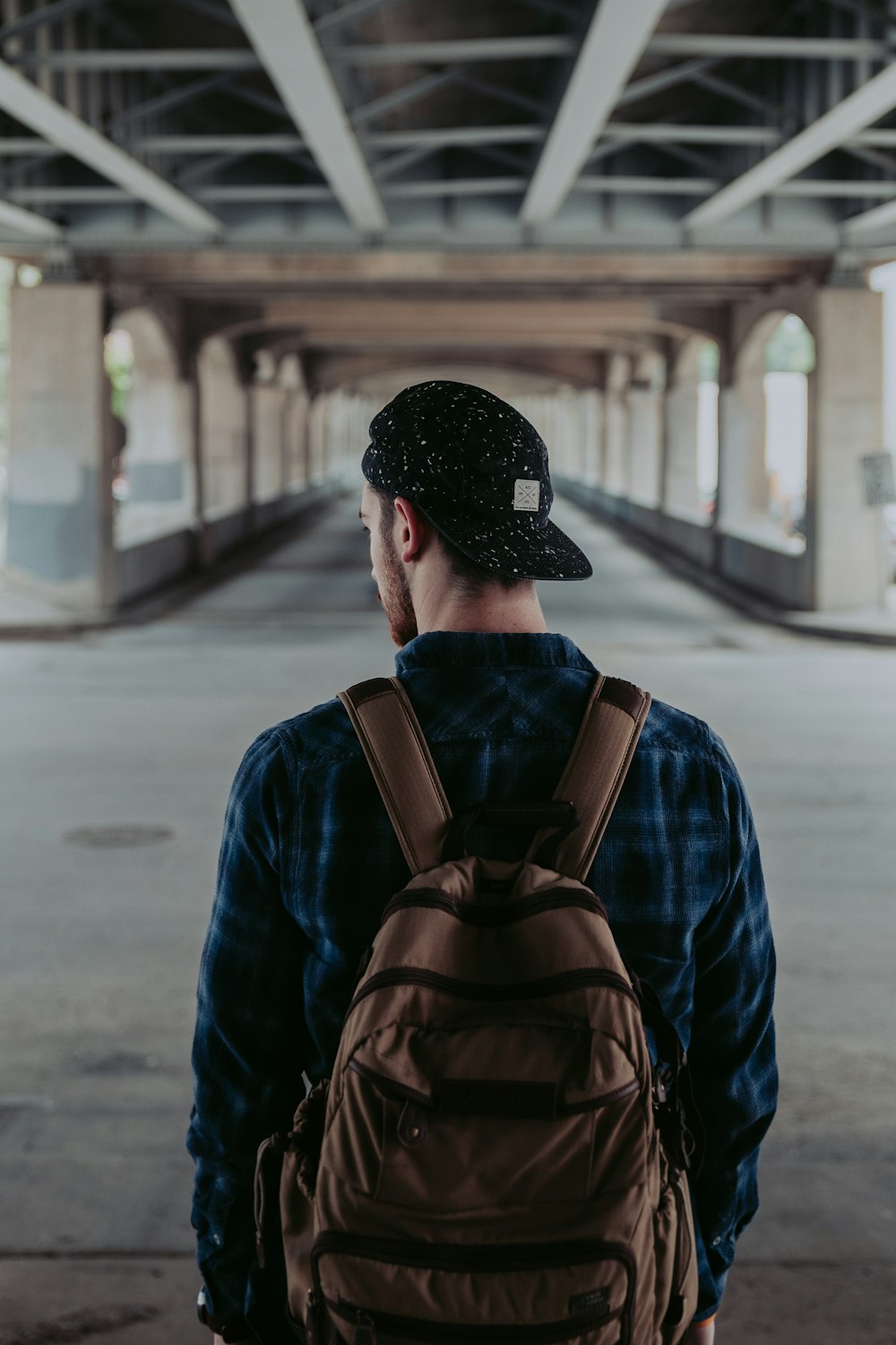 man standing under the bridge