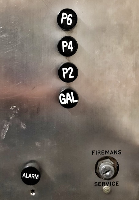 Fire alarm control panel with illuminated indicators in a commercial building