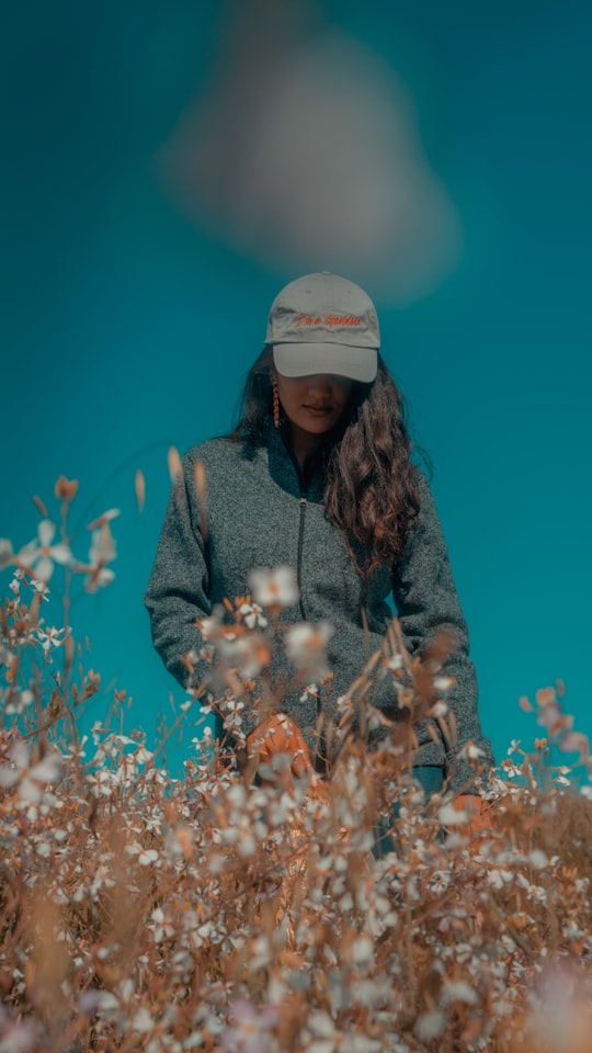 woman surrounded with white flowers in California State University United States