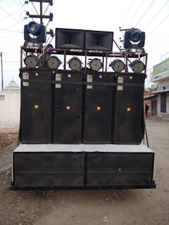 Professional sound system with large speakers arranged neatly for a festival stage
