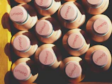 Top view of multiple detox juice bottles lined up on a sleek black surface with subtle pink accents.