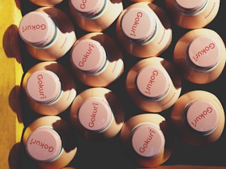 A vibrant assortment of goro's colorful natural beverage bottles arranged on a rustic wooden table.