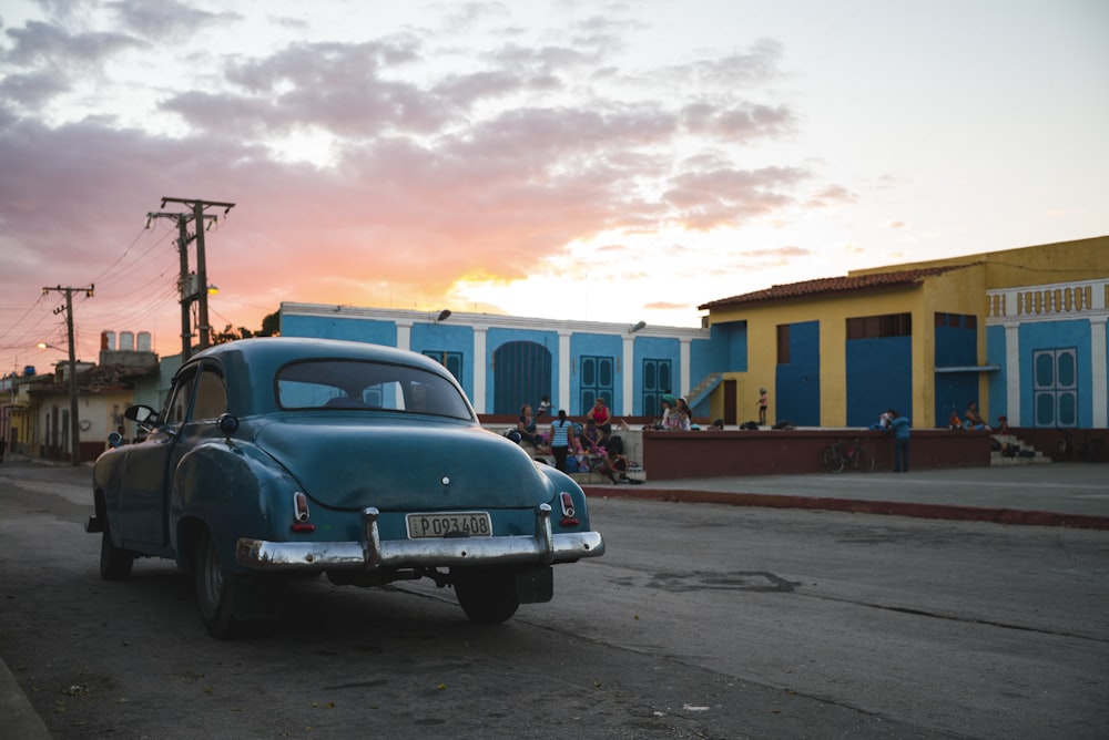 an old car parked on the side of the road