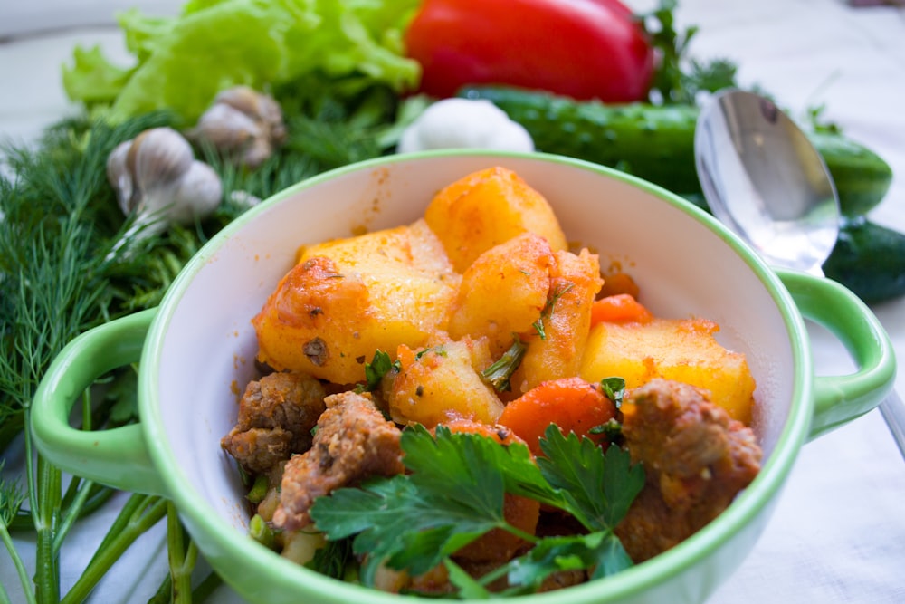 meat dish on green and white ceramic bowl