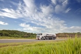 white and black storage truck on gray asphalt road