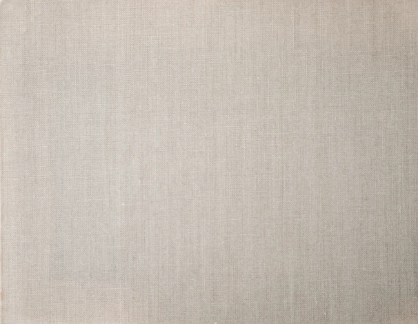 Close-up of soft cotton fabric with subtle texture in a neutral tone.