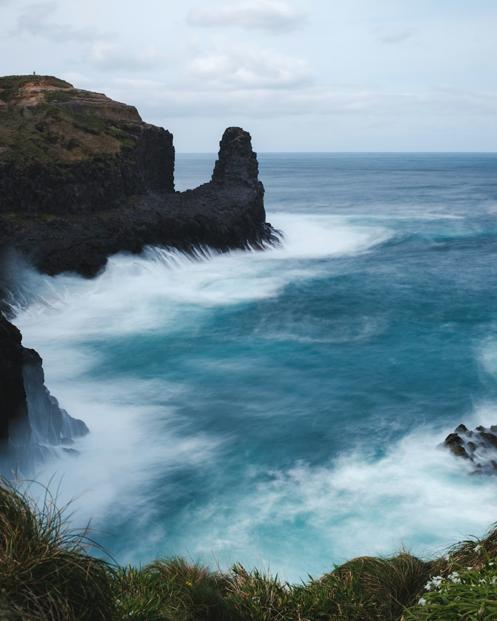 ocean water under gray sky