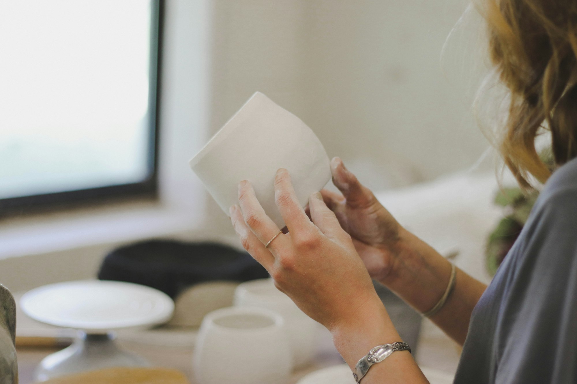 My friend Syd is a ceramic artist, and I did a lifestyle shoot with her. she was working on some final shaping on a few pots, and this shot is her surveying her work. Though her art has rough and moody vibes, she so carefully and patiently forms her ceramics. She lets her works become natural and undone art in the most delicately organic way.