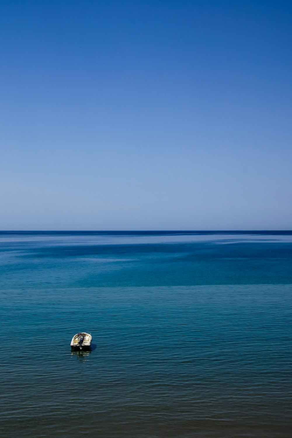 white boat on body of water