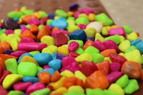 Colorful tokens scattered on a bright surface.