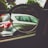 A pair of eyeglasses held up to a car window, focusing on the car outside. The lens frames the vehicle, highlighting the contrast between the lens-focused sharpness and the blurred surroundings.