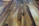 Close-up of a newly installed polished hardwood floor in a cozy living room.