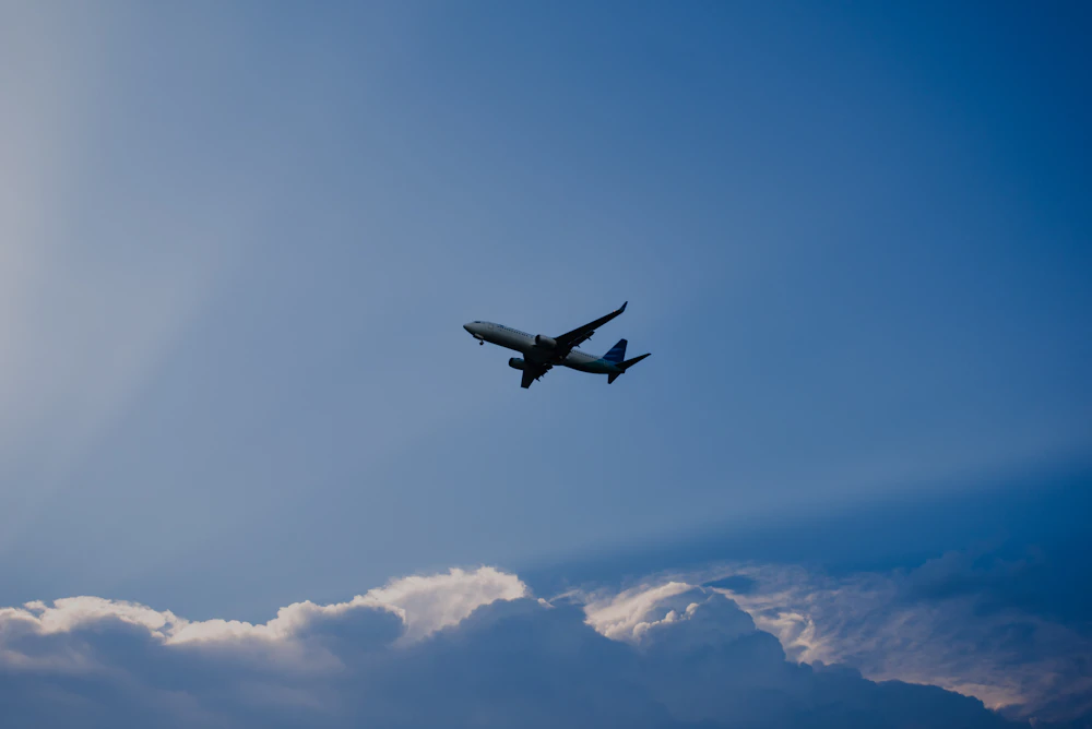 Airplane flying in blue sky