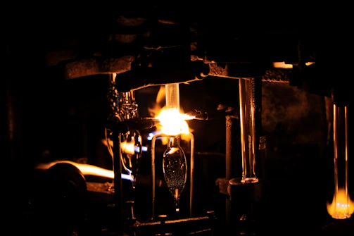 Red industrial fire-resistant cabinet glowing subtly under workshop lights.